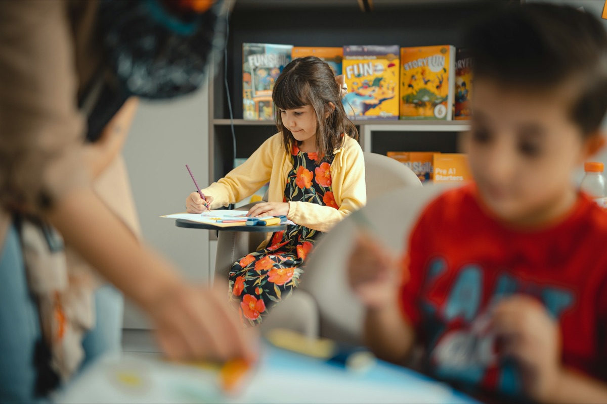 A girl painting in a classroom